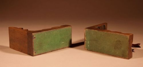 A pair of carved brown wooden bookends depicting goldfish figures mounted on angular wooden bases. View VIII