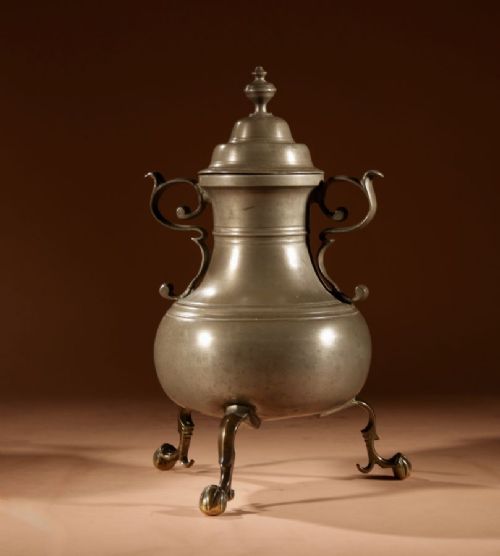 An 18th-century Dutch pewter kraantjeskan coffee urn featuring a bronze spigot tap, curved side handles, and three cabriole feet. View V