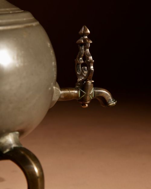 An 18th-century Dutch pewter kraantjeskan coffee urn featuring a bronze spigot tap, curved side handles, and three cabriole feet. View VIII