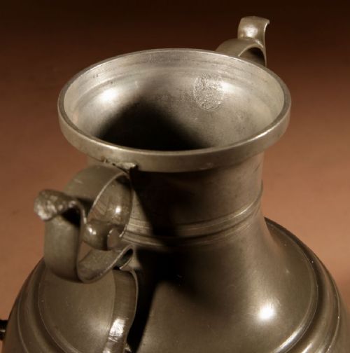 An 18th-century Dutch pewter kraantjeskan coffee urn featuring a bronze spigot tap, curved side handles, and three cabriole feet. View XIV