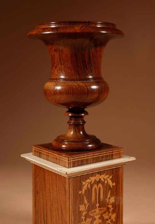 A French Louis Philippe portico mantel clock set featuring floral wood inlay, architectural columns, a gilt metal pendulum, and two matching urn side pieces on decorative pedestals. View XI