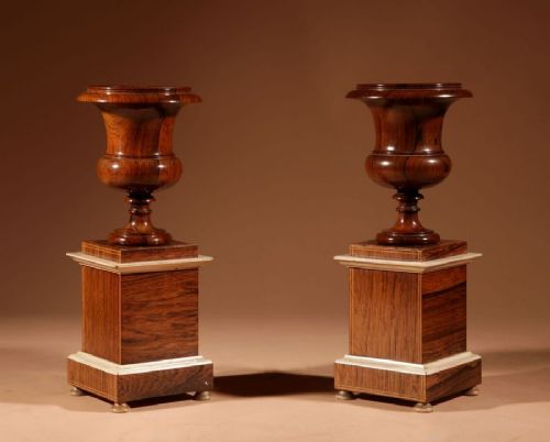 A French Louis Philippe portico mantel clock set featuring floral wood inlay, architectural columns, a gilt metal pendulum, and two matching urn side pieces on decorative pedestals. View XIII