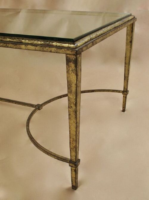 A rectangular gilded wrought iron coffee table featuring a clear glass inserted top and a curved stretcher base. View II