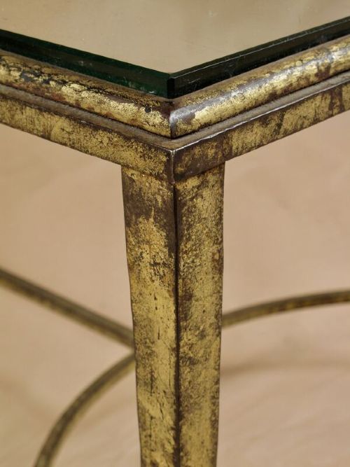 A rectangular gilded wrought iron coffee table featuring a clear glass inserted top and a curved stretcher base. View III