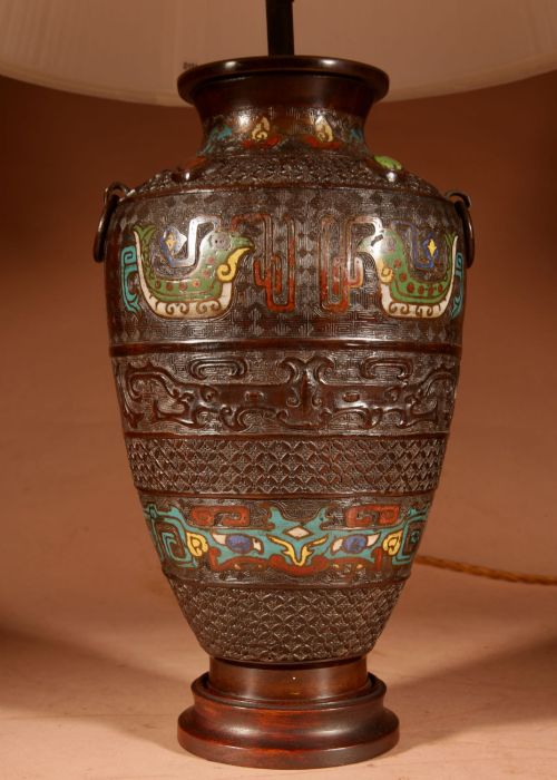 fig 2. A Japanese cast bronze table lamp decorated with polychrome champleve enamel band motifs and fitted with a pleated cream shade.