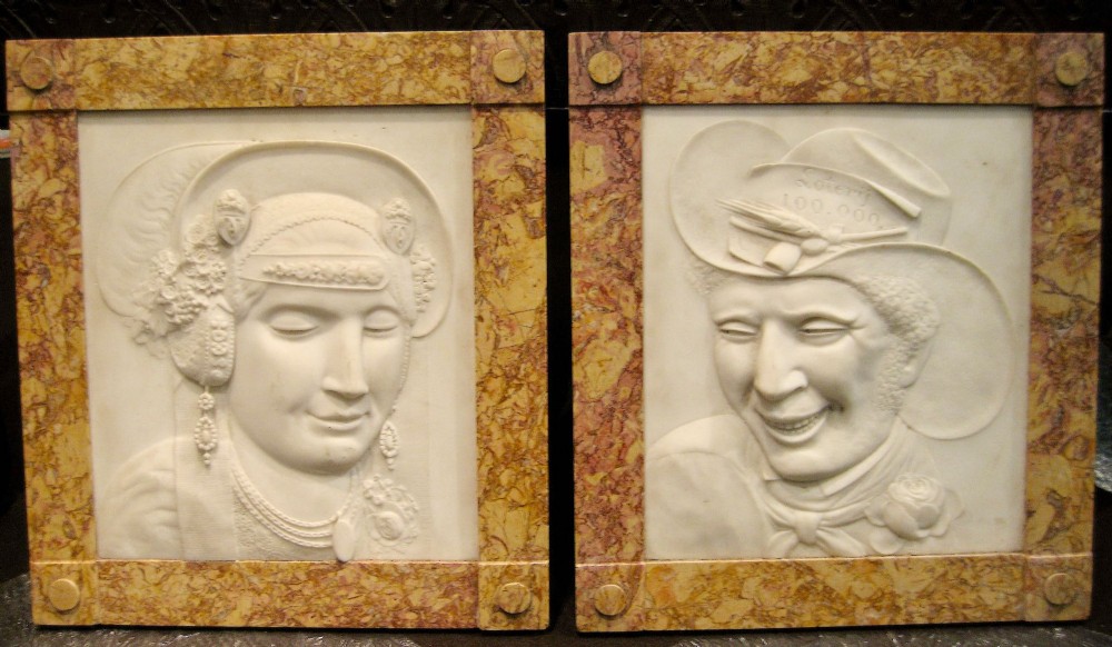 A pair of square carved white marble relief plaques depicting portrait busts set within ochre marble frames.