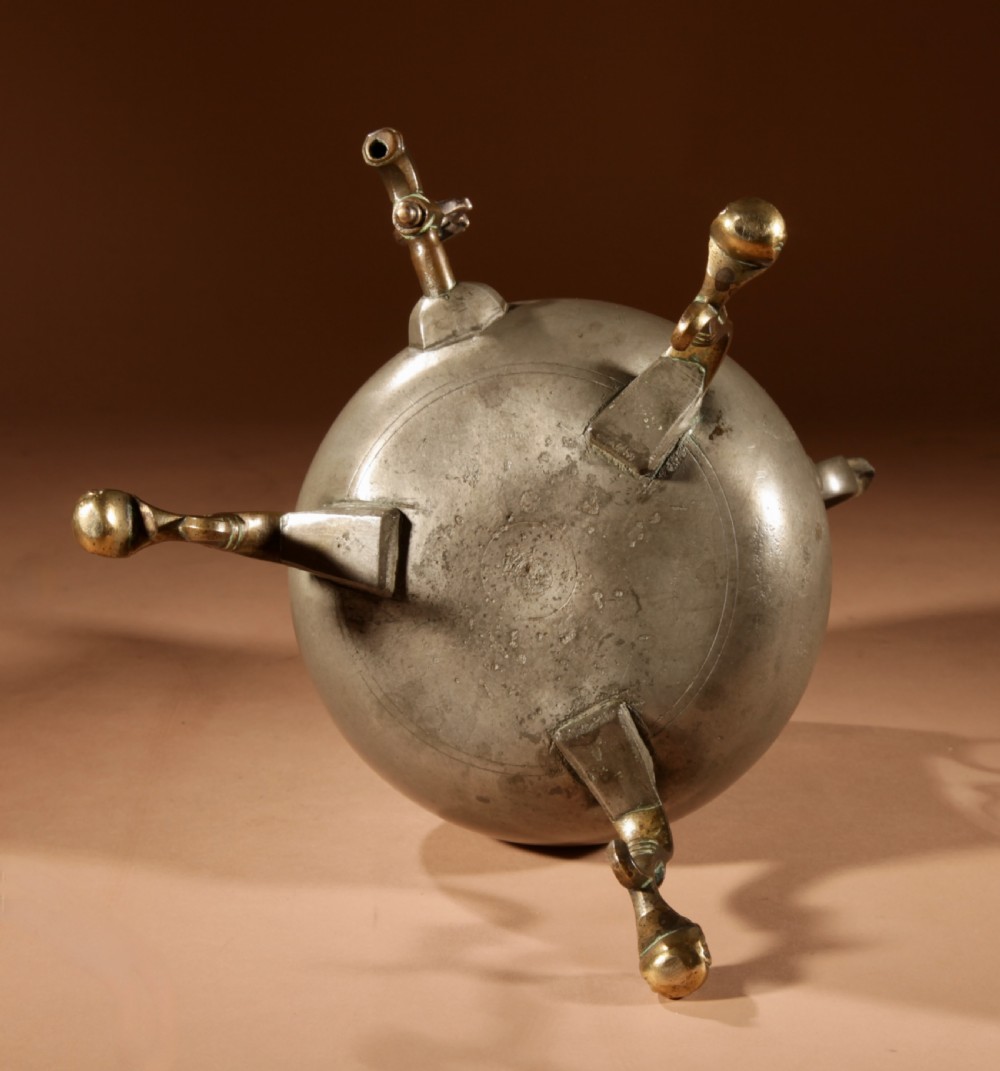 An 18th-century Dutch pewter coffee urn featuring a bulbous body, brass spigot, twin handles, and tripod bronze legs. View XIII