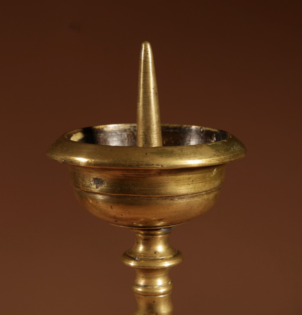 A pair of 17th-century Flemish turned brass pricket candlesticks with spiral shafts and ornate tripod claw feet. View III