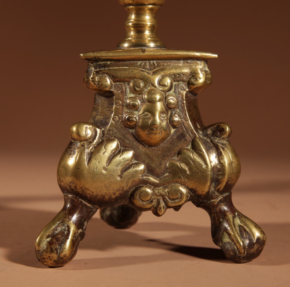 A pair of 17th-century Flemish turned brass pricket candlesticks with spiral shafts and ornate tripod claw feet. View V