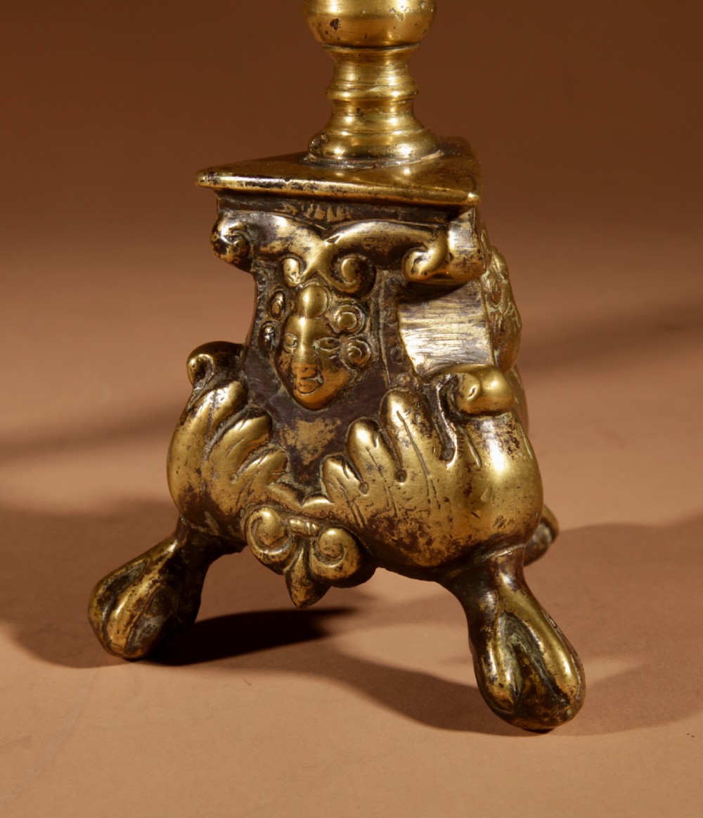A pair of 17th-century Flemish turned brass pricket candlesticks with spiral shafts and ornate tripod claw feet. View VII