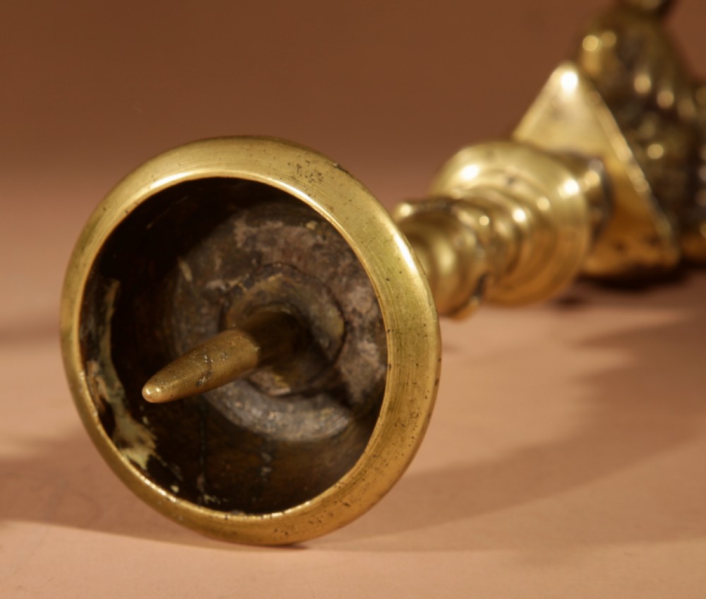 A pair of 17th-century Flemish turned brass pricket candlesticks with spiral shafts and ornate tripod claw feet. View IX