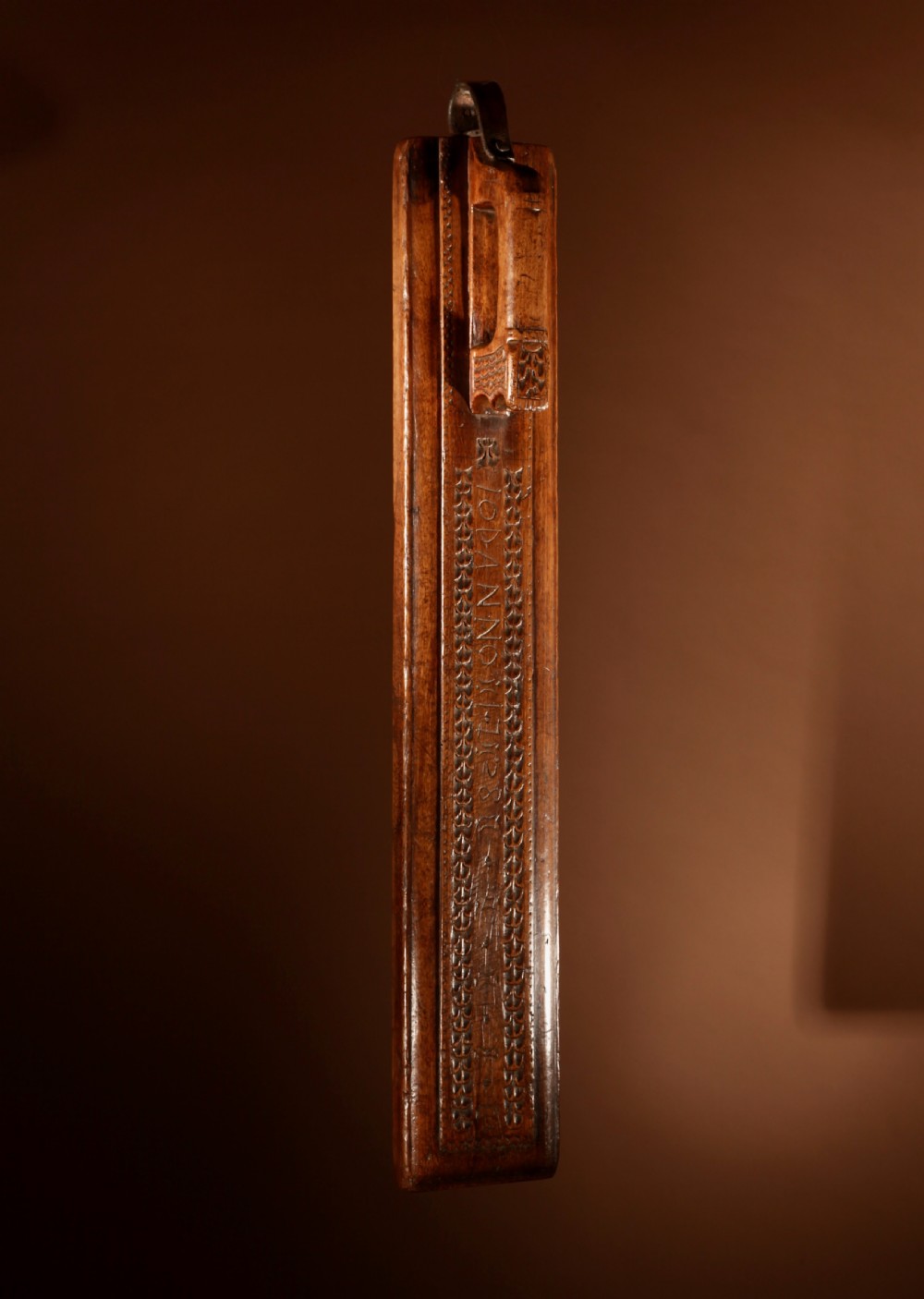 A hand-carved 18th-century Norwegian wooden mangle board with geometric chip carving, dated 1728, featuring a raised carved handle at one end. View III