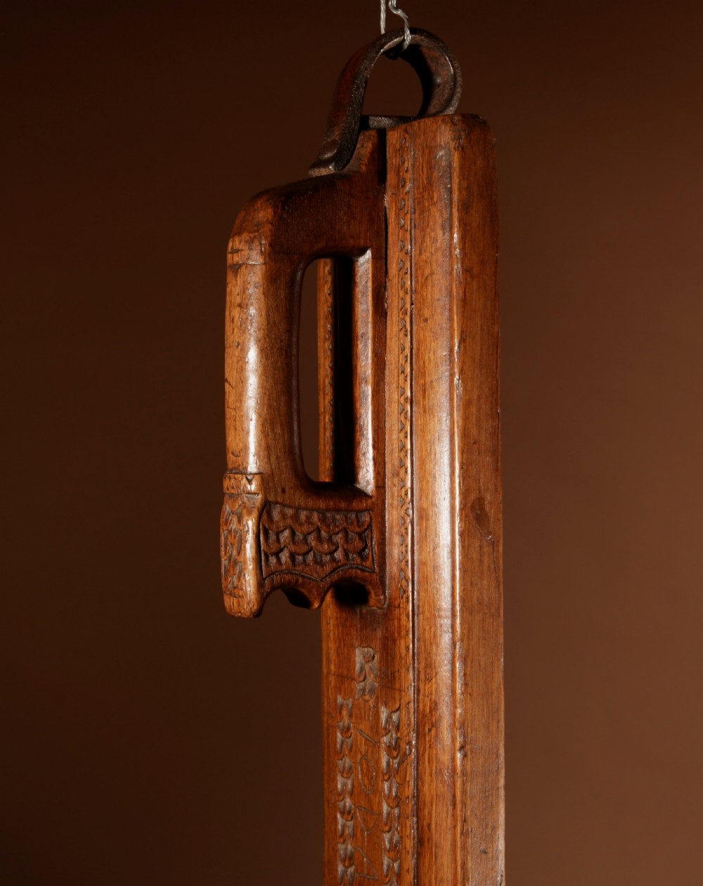 A hand-carved 18th-century Norwegian wooden mangle board with geometric chip carving, dated 1728, featuring a raised carved handle at one end. View IV