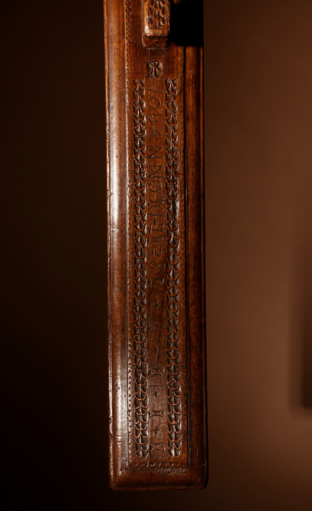 A hand-carved 18th-century Norwegian wooden mangle board with geometric chip carving, dated 1728, featuring a raised carved handle at one end. View VI