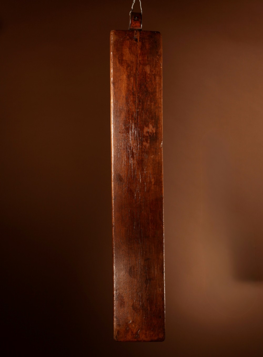 A hand-carved 18th-century Norwegian wooden mangle board with geometric chip carving, dated 1728, featuring a raised carved handle at one end. View VII
