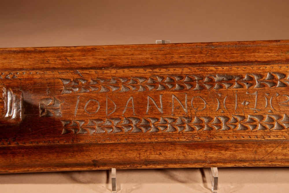 A hand-carved 18th-century Norwegian wooden mangle board with geometric chip carving, dated 1728, featuring a raised carved handle at one end. View VIII