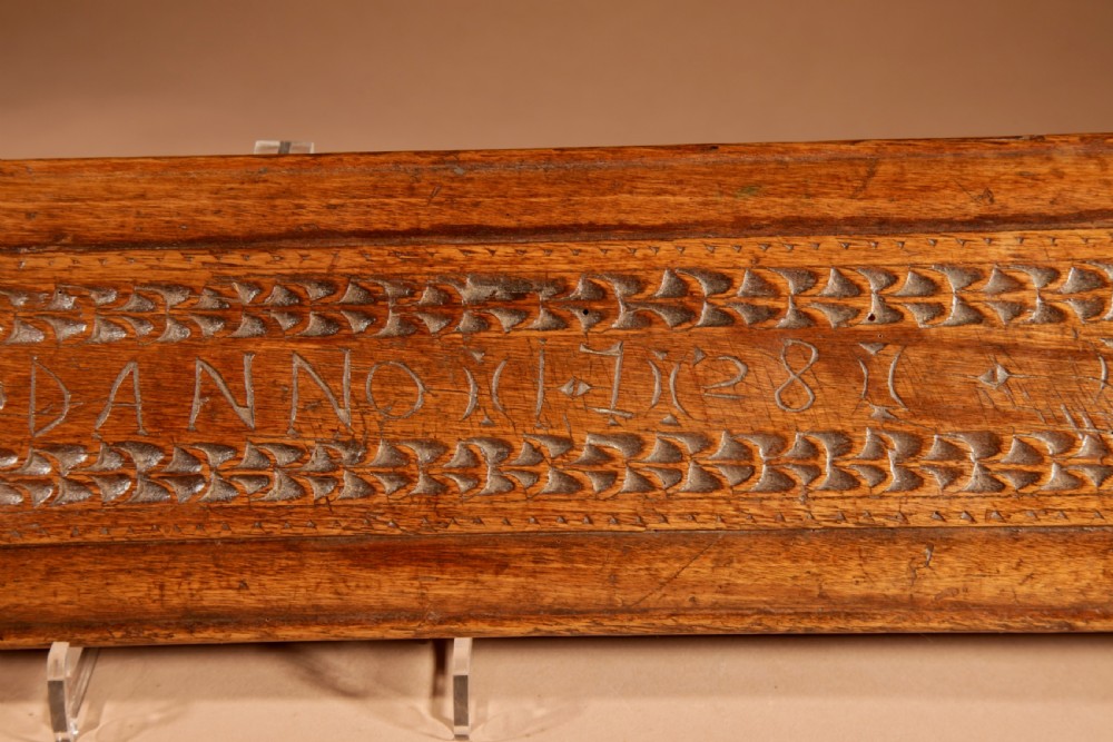 A hand-carved 18th-century Norwegian wooden mangle board with geometric chip carving, dated 1728, featuring a raised carved handle at one end. View IX
