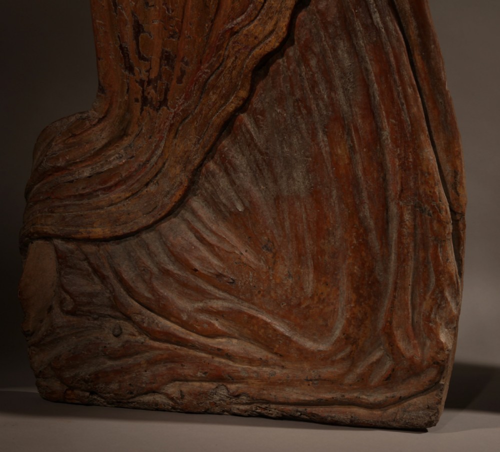 A pair of 16th-century carved wood polychrome relief sculptures depicting a kneeling man and woman facing each other with hands folded in prayer. View V
