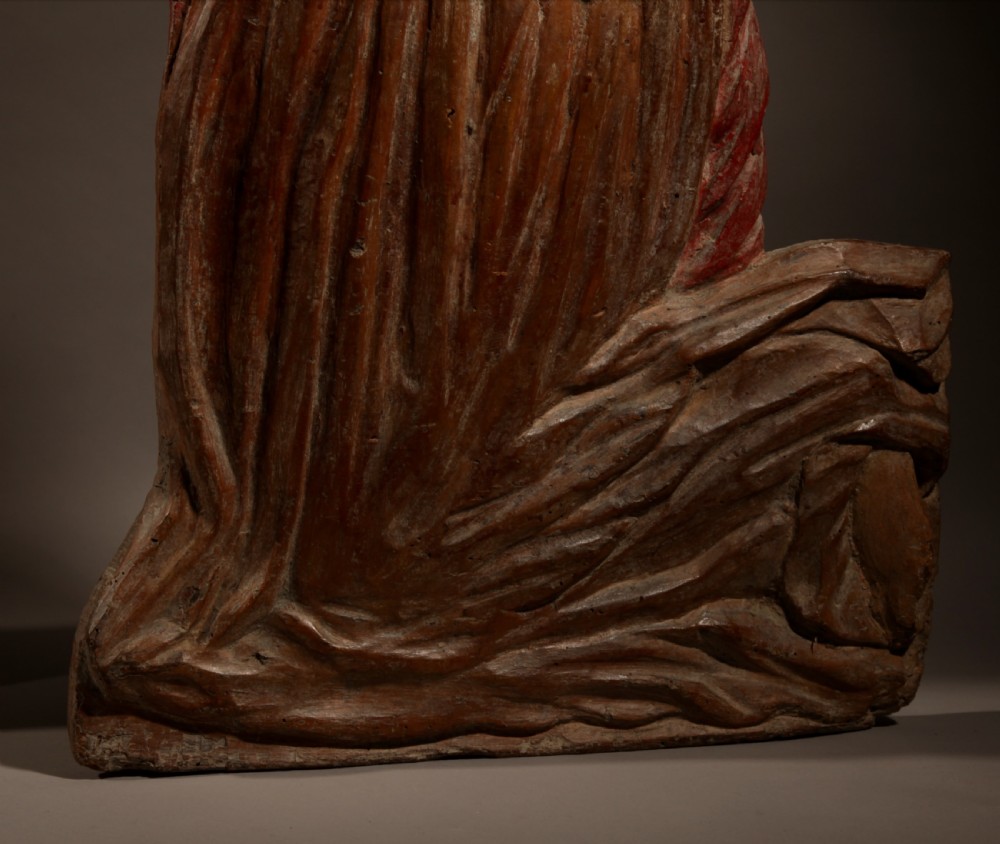 A pair of 16th-century carved wood polychrome relief sculptures depicting a kneeling man and woman facing each other with hands folded in prayer. View VII