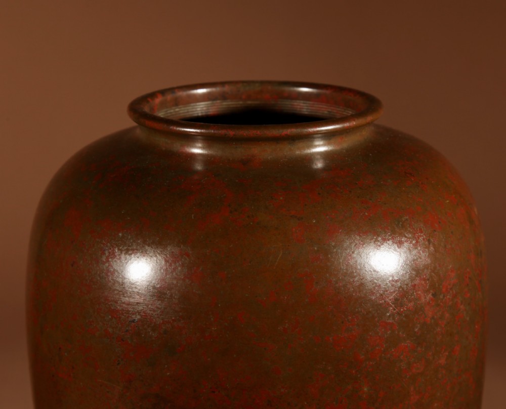 A Japanese bronze vase with a mottled red and brown patinated surface and an ovoid silhouette. View II