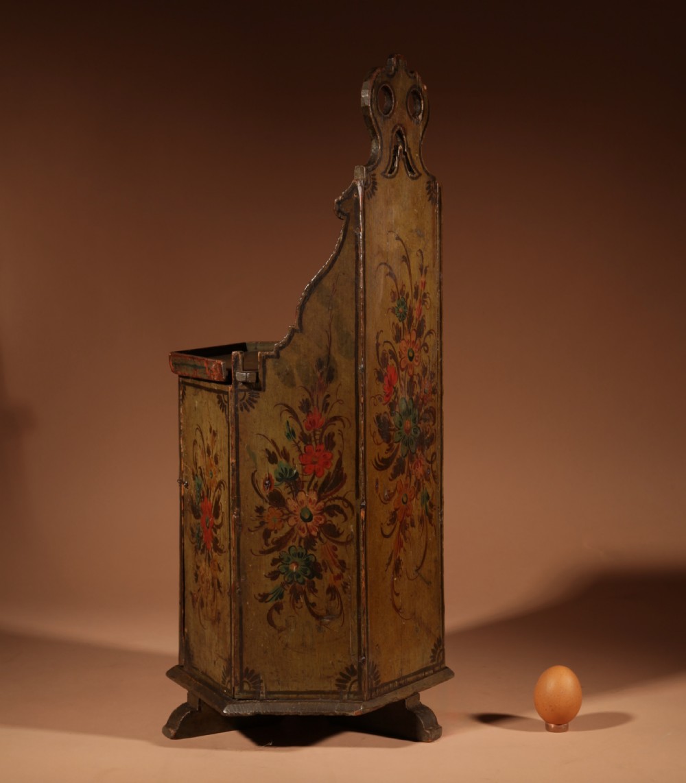An 18th-century miniature Dutch Hindeloopen style green painted wooden doll chair featuring hand-painted floral motifs and an enclosed cabinet base. View VI