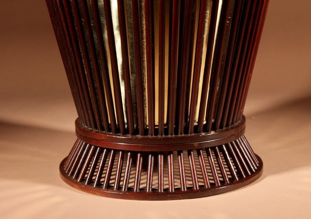 A 19th-century mahogany peat bucket constructed with open vertical spindles, a fitted brass interior liner, and a swinging brass handle. View III