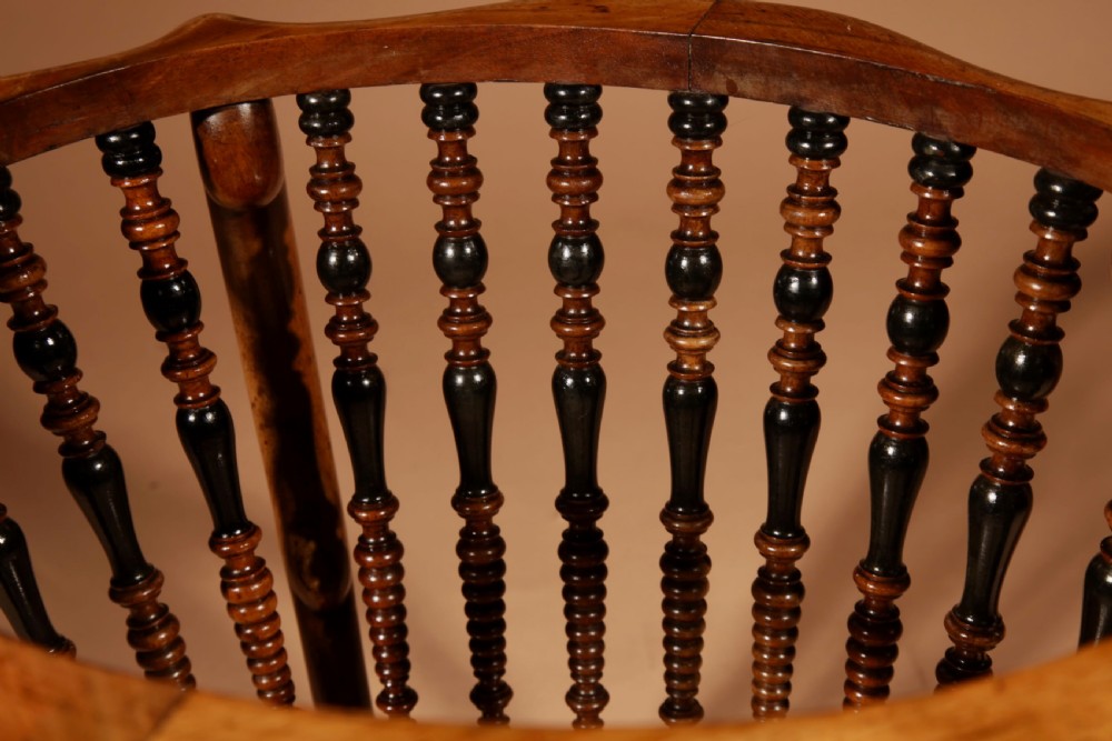An oval Victorian walnut peat bucket featuring turned dual-tone spindles, four curved legs, and a swing-handled brass liner. View XI