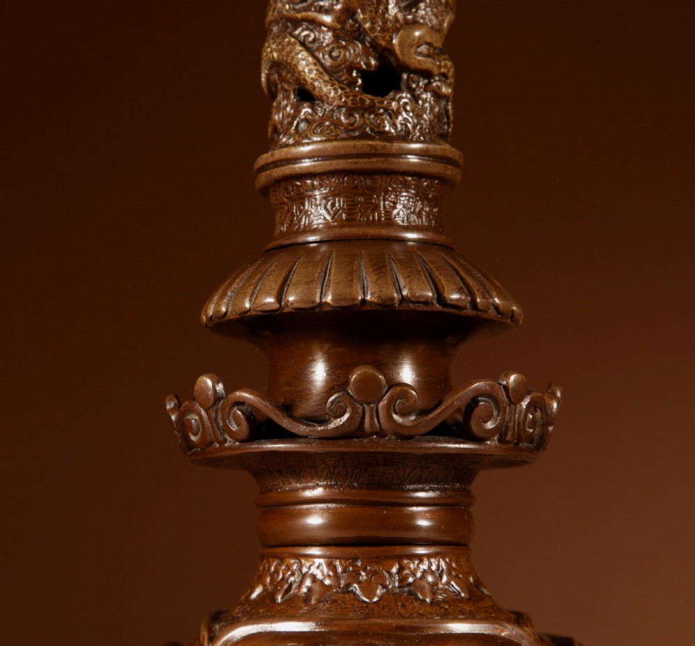 A dark patinated bronze table lamp featuring cast elephant and dragon motifs topped with a pleated conical lampshade. View VI