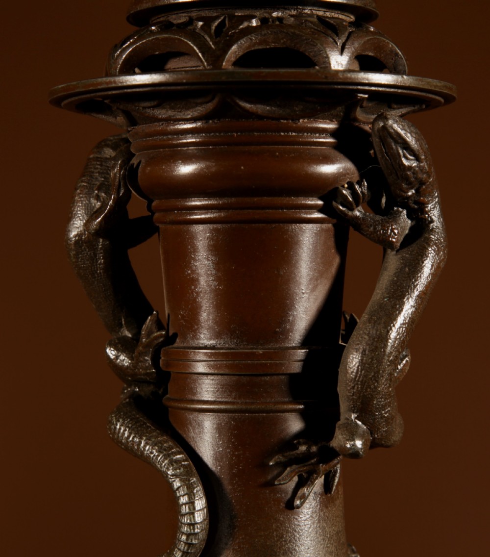 A dark patinated metal table lamp with relief dragon decoration, fitted with a pleated flared lampshade. View V