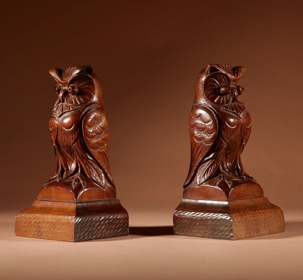 A pair of hand-carved dark wood owl figures with glass eyes mounted on carved wooden bases. View IV