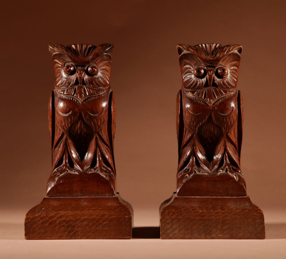 A pair of hand-carved dark wood owl figures with glass eyes mounted on carved wooden bases. View VI