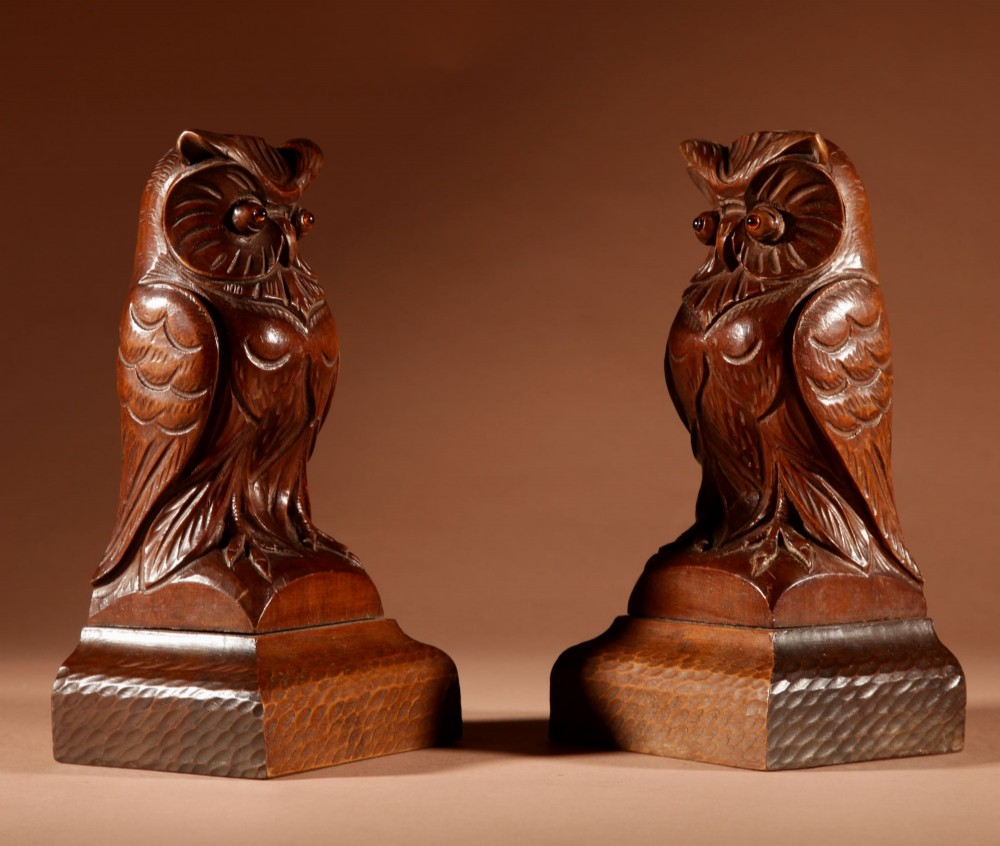 A pair of hand-carved dark wood owl figures with glass eyes mounted on carved wooden bases. View VII