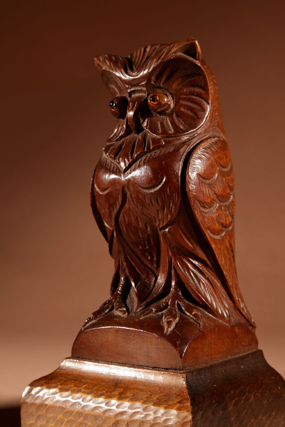 A pair of hand-carved dark wood owl figures with glass eyes mounted on carved wooden bases. View VIII