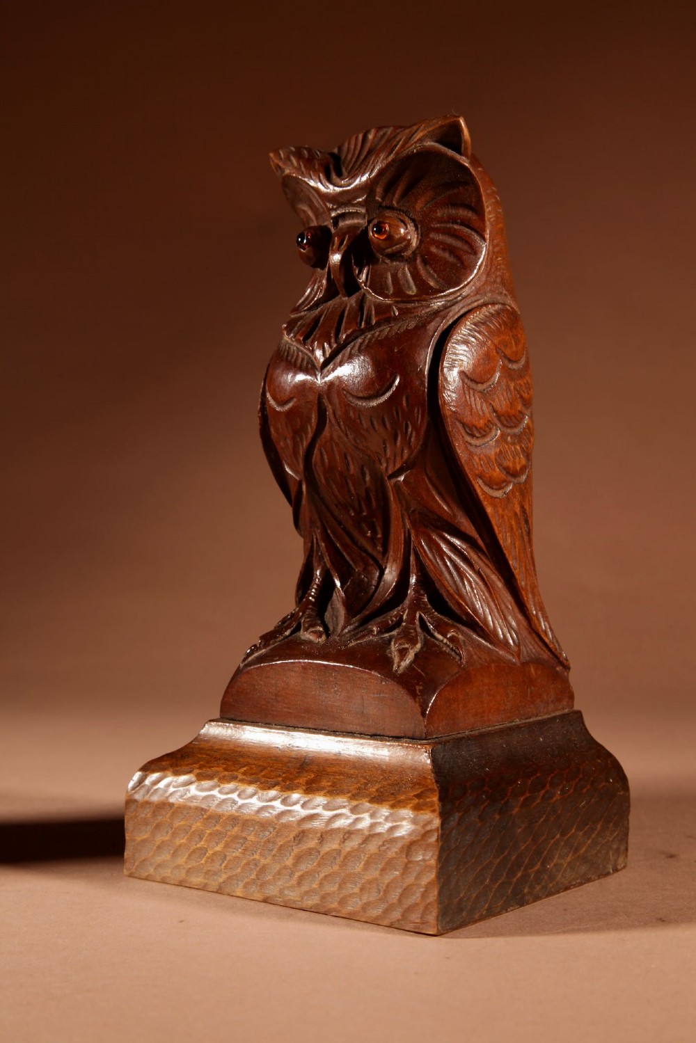 A pair of hand-carved dark wood owl figures with glass eyes mounted on carved wooden bases. View IX
