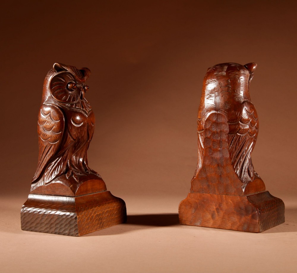 A pair of hand-carved dark wood owl figures with glass eyes mounted on carved wooden bases. View XII