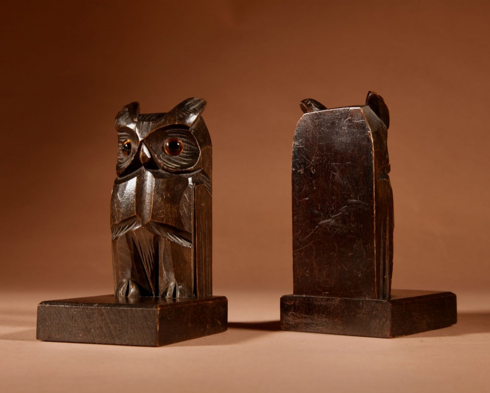 A pair of hand-carved dark wood owl bookends with inset glass eyes, standing on rectangular wooden bases. View IV