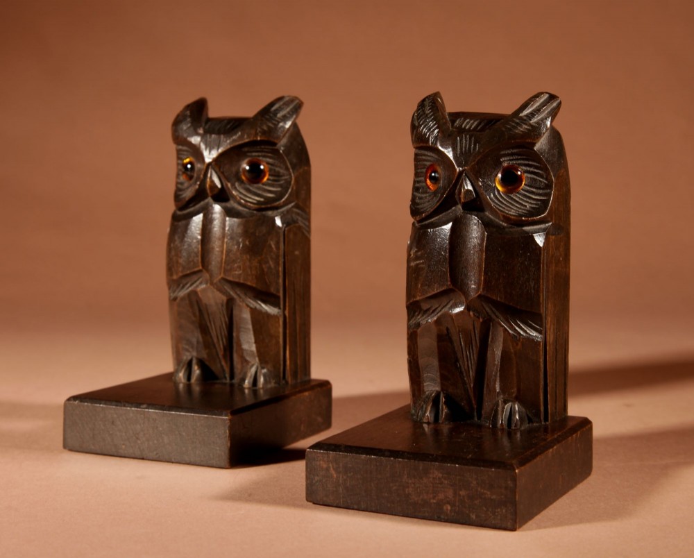 A pair of hand-carved dark wood owl bookends with inset glass eyes, standing on rectangular wooden bases. View VI