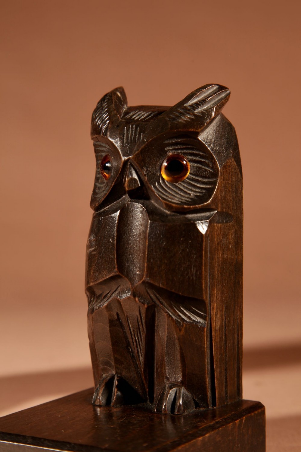 A pair of hand-carved dark wood owl bookends with inset glass eyes, standing on rectangular wooden bases. View VII