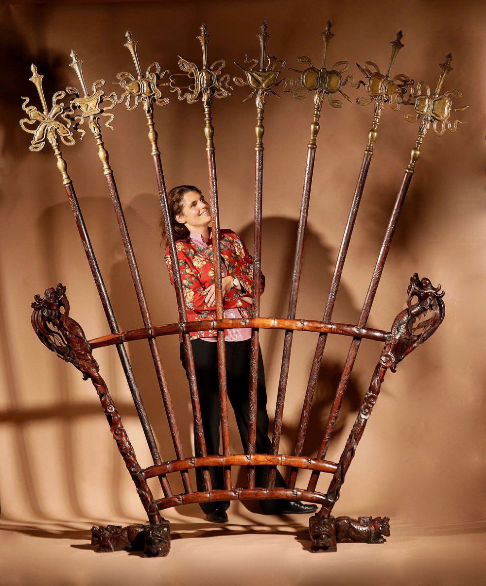 A large 19th-century Chinese ceremonial stand crafted from dark carved hardwood displaying a fan-shaped arrangement of polearms topped with brass finials.