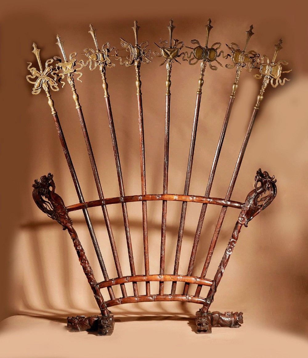 A large 19th-century Chinese ceremonial stand crafted from dark carved hardwood displaying a fan-shaped arrangement of polearms topped with brass finials. View II