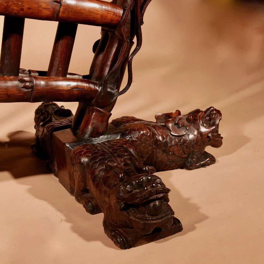 A large 19th-century Chinese ceremonial stand crafted from dark carved hardwood displaying a fan-shaped arrangement of polearms topped with brass finials. View V