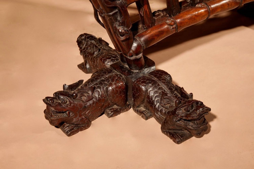A large 19th-century Chinese ceremonial stand crafted from dark carved hardwood displaying a fan-shaped arrangement of polearms topped with brass finials. View VI