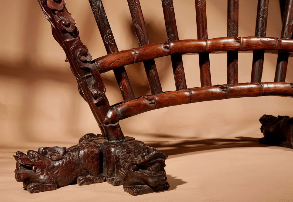 A large 19th-century Chinese ceremonial stand crafted from dark carved hardwood displaying a fan-shaped arrangement of polearms topped with brass finials. View VII