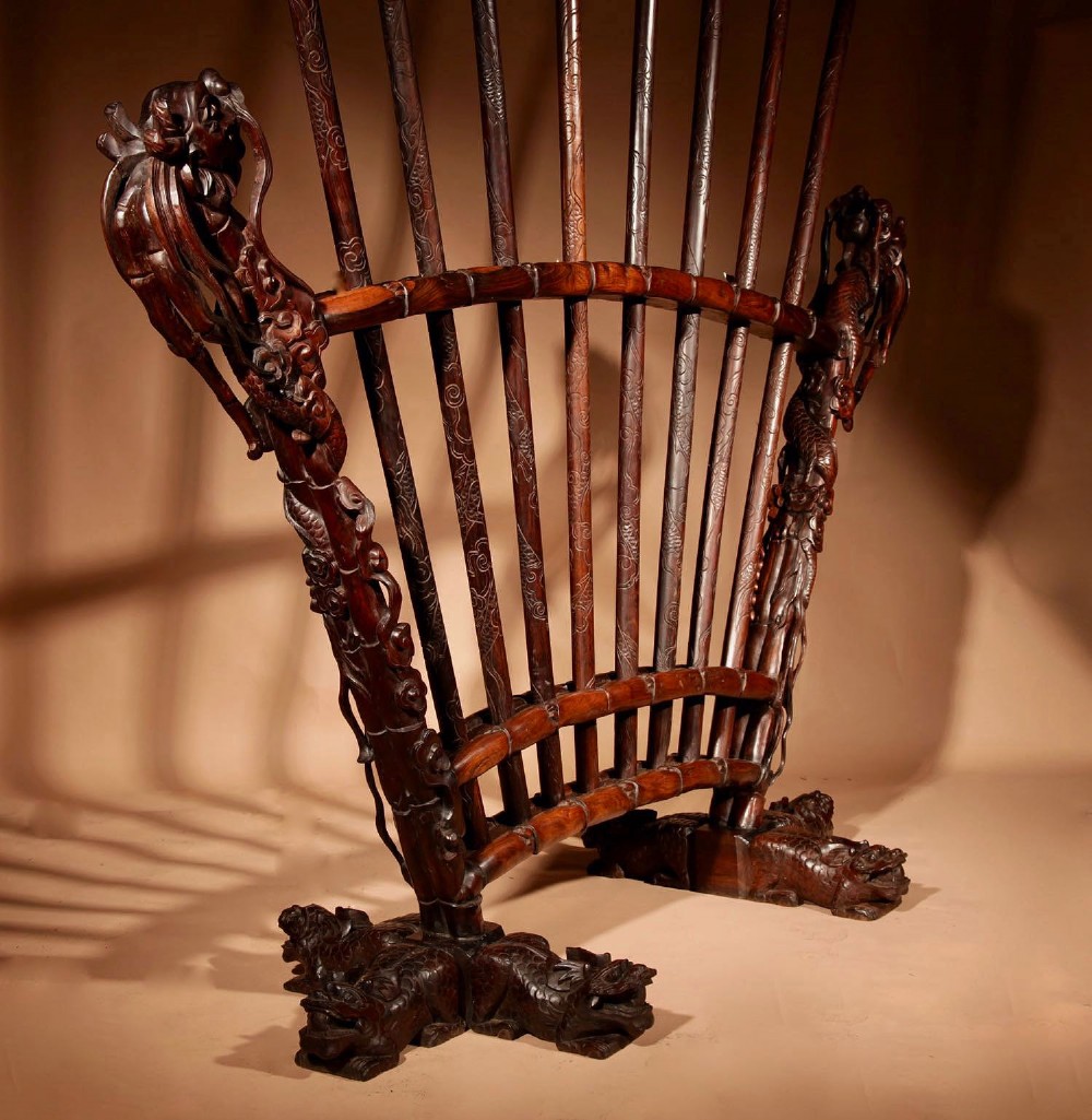 A large 19th-century Chinese ceremonial stand crafted from dark carved hardwood displaying a fan-shaped arrangement of polearms topped with brass finials. View XI