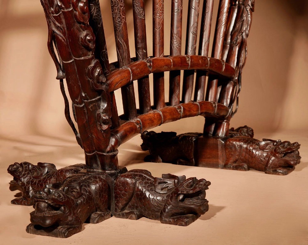 A large 19th-century Chinese ceremonial stand crafted from dark carved hardwood displaying a fan-shaped arrangement of polearms topped with brass finials. View XII