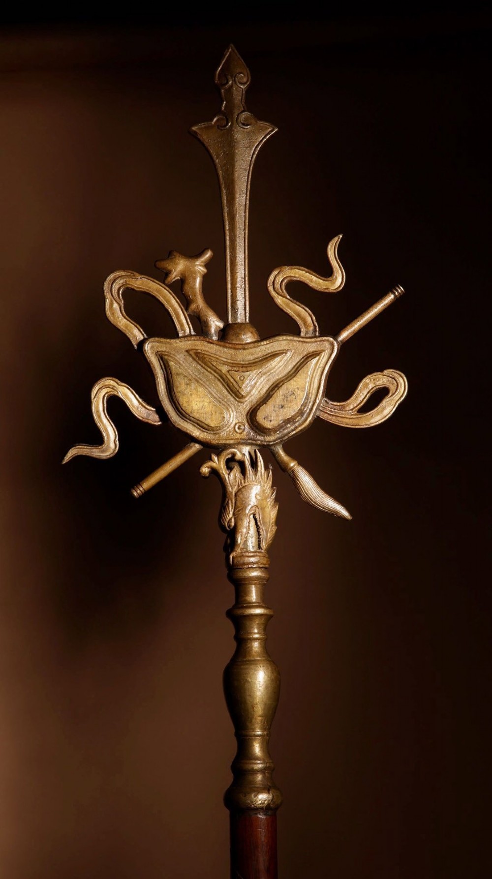A large 19th-century Chinese ceremonial stand crafted from dark carved hardwood displaying a fan-shaped arrangement of polearms topped with brass finials. View XIV