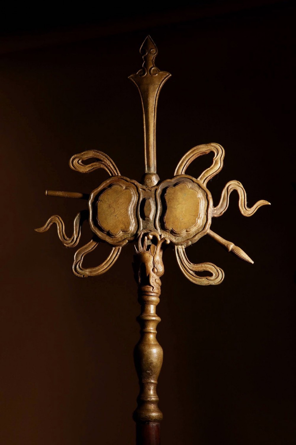 A large 19th-century Chinese ceremonial stand crafted from dark carved hardwood displaying a fan-shaped arrangement of polearms topped with brass finials. View XV