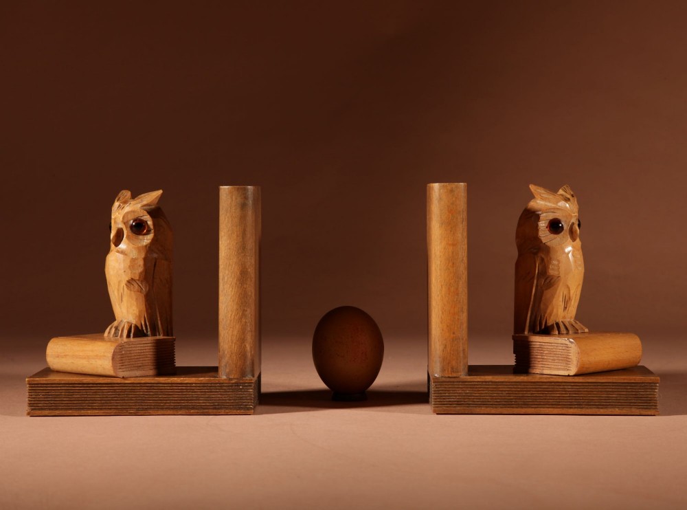 A pair of carved wooden owl bookends positioned on bases shaped like stacked books with amber glass eyes. View II