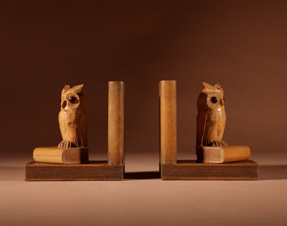 A pair of carved wooden owl bookends positioned on bases shaped like stacked books with amber glass eyes. View III