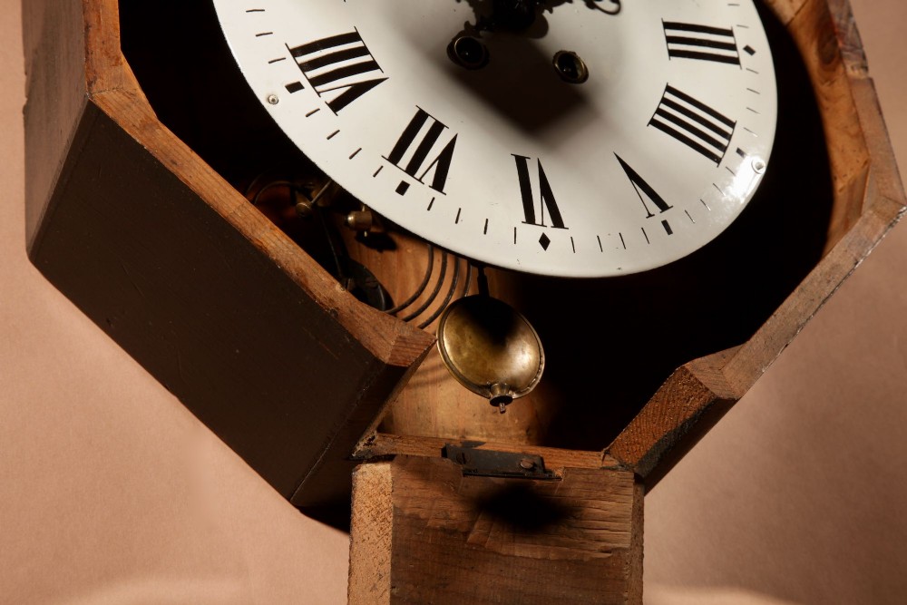 An ebonised French wall clock featuring a scalloped outer frame with floral mother-of-pearl inlay, a brass bezel, and a white dial with black Roman numerals. View VII
